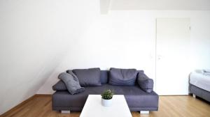 a living room with a couch and a table at Zwei Ferienwohnungen in Randersacker in Randersacker