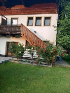 a house with a staircase and flowers in the yard at Apartment Oberberghof by Interhome in Uttendorf