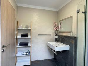 a bathroom with a sink and a mirror at Apartment Joel by Interhome in Stockach