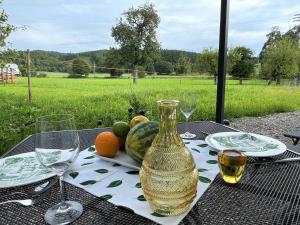 a table with a bottle of wine and fruit on it at Apartment Joel by Interhome in Stockach
