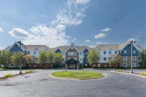a large apartment complex with a circular driveway at Candlewood Suites Eagan - Mall of America Area, an IHG Hotel in Eagan