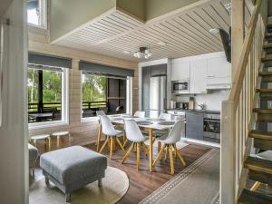 a kitchen and dining room with a table and chairs at Holiday Home Himoksen keiju 1 by Interhome in Jämsä