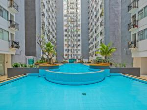 The swimming pool at or close to OYO Life 92649 Jarrdin Apartment By Glory