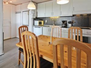 a kitchen with a wooden dining room table and chairs at Apartment Gertruda - 2-3km from the sea in Western Jutland by Interhome in Havneby