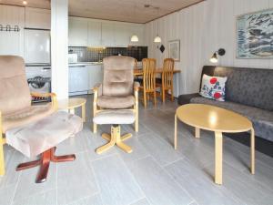 a living room with a couch and a table and chairs at Apartment Gertruda - 2-3km from the sea in Western Jutland by Interhome in Havneby