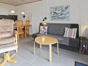 a living room with a couch and a table at Apartment Gertruda - 2-3km from the sea in Western Jutland by Interhome in Havneby