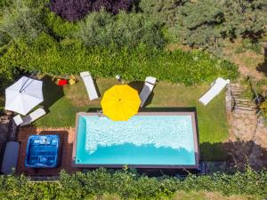 an overhead view of a swimming pool with a yellow umbrella at Holiday Home Ridaldi by Interhome in Greve in Chianti
