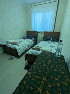 sypialnia z 2 łóżkami i stołem z kocem w obiekcie Apartament motel w Kiszyniowie