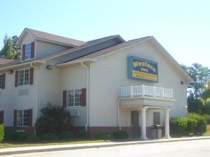 a building with a sign that reads western inn at Western Inn & Suites Hampton in Hampton