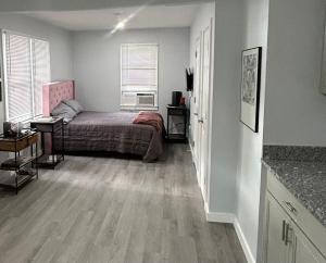 a bedroom with a bed and a desk and a window at The Oasis in Sanford