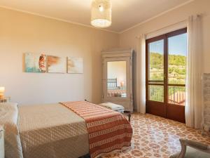 a bedroom with a bed and a large window at Apartment Villa Michelle by Interhome in Bardino Nuovo