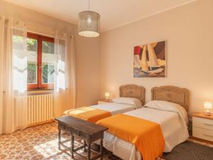 a bedroom with two beds and a window at Apartment Villa Michelle by Interhome in Bardino Nuovo