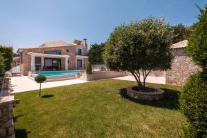 an image of a villa with a tree in a yard at Shemesh Residence in Nafplio