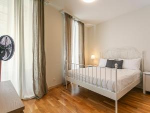 a bedroom with a white bed and a large window at Apartment Le Jazz by Interhome in Montreux