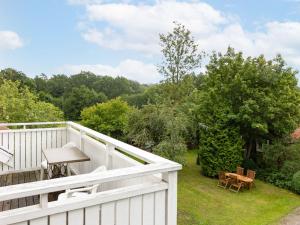 a balcony with a white fence and a table at Holiday Home Arvidstorp by Interhome in Johannishus