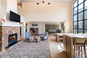 a living room with a fireplace and a table and chairs at Candlewood Suites Eagan - Mall of America Area, an IHG Hotel in Eagan