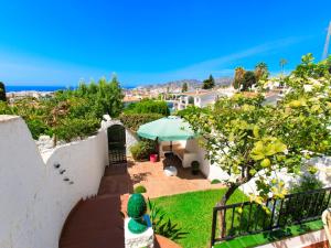 a woman standing on a balcony looking at the ocean at Apartment Limoneros by Interhome in Nerja