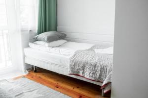 a bed in a room with a green curtain at Willa JODŁA Wisła in Wisła +138 photos