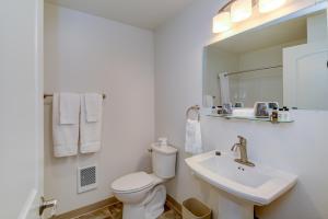 a white bathroom with a toilet and a sink at Roosevelt Hotel & Cabins - Yellowstone in Gardiner +36 photos