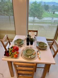 a table with a plate of fruit on it at Beskid Apartamenty in Nowy Sącz
