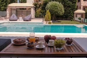 a tray of food on a table next to a pool at Shemesh Residence in Nafplio