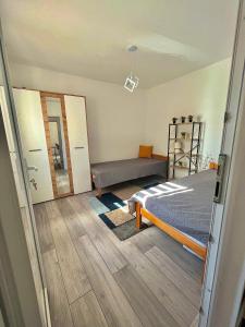 a bedroom with a bed and a bench in it at Apartman "Lola" in Pirot