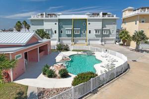 an aerial view of a swimming pool in front of a house at Port A Del Rey in Port Aransas