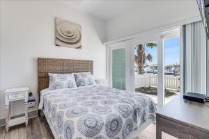 a bedroom with a bed and a view of the ocean at Port A Del Rey in Port Aransas +117 photos
