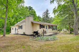 a small yellow house with a yard at Cozy Montello Hideaway Near Puckaway Lake Access! in Montello