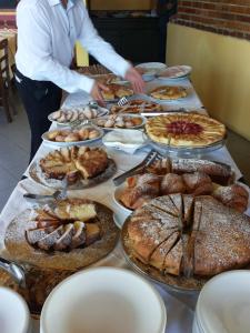 a table with many different types of pastries and pies at Park Hotel Cilento in Marina di Camerota