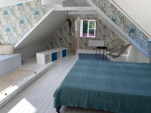 a attic bedroom with a bed and a staircase at Haus Lasse in Immeln