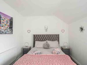 a bedroom with a large bed with two night stands at Beeches Bach, 1 bedroom cottage with hot tub in Prestatyn