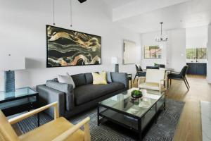 a living room with a couch and a table at Spacious Modern Apartments at Hideaway North Scottsdale close to Kierland Commons in Scottsdale