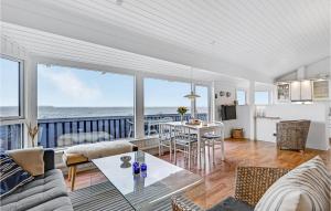a living room with a view of the ocean at Stunning Home In Ebeltoft With 2 Bedrooms And Wifi in Ebeltoft