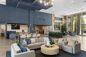 a lobby with couches and a table and chairs at Premium One and Two Bedroom Apartments at Slate Scottsdale in Phoenix Arizona in Scottsdale