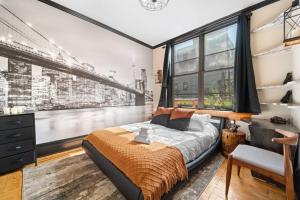 a bedroom with a bed and a large window at Artistic Loft A Century-Old Gem in Brooklyn