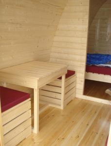 a sauna with a bench and a bed in a room at Vinland Camping Pods in Egilsstadir