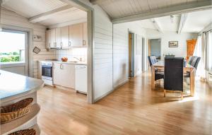 a kitchen and dining room with a table at Awesome Home In Ebeltoft With 3 Bedrooms, Sauna And Wifi in Ebeltoft