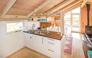 a kitchen in a tiny house with a sink at Stunning Home In Hirtshals With 2 Bedrooms, Sauna And Wifi in Hirtshals