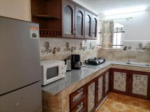 A kitchen or kitchenette at Roshnee Apartments and Studios