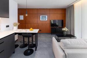 a kitchen and living room with a table and a couch at Calatrava by Alma Suites in Valencia