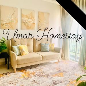 a couch in a living room with the words linen therapy at UMAR HOMESTAY - Alanis KLIA in Sepang