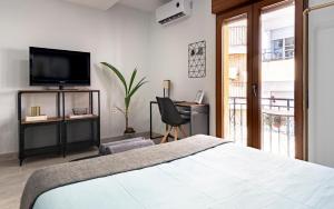 A bed or beds in a room at Oleti Studio Granada