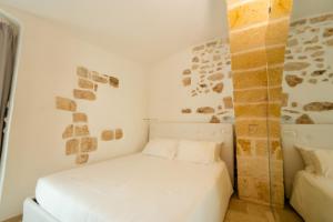 En eller flere senger på et rom på Apulian Escapes - Suite Il Fico