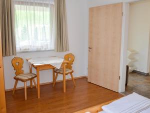 a room with a table and two chairs and a window at Apartment Schöngraben by Interhome in Sankt Jakob