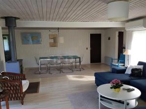 a living room with a blue couch and a table at Holiday Home Asmine - 670m from the sea in Lolland- Falster and Mon by Interhome in Dannemare