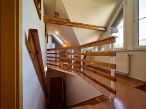 a wooden staircase in a room with a window at Apartment Harrachov 497-2 by Interhome in Harrachov