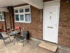 a group of chairs and a table next to a door at Chilled space that sleeps upto 4 in Barking