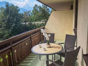 a table and chairs on a balcony with a view at Apartment Kitzblick by Interhome in Zell am See