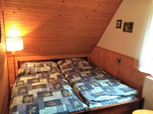 a bedroom with two beds in a attic at Holiday Home Jahor by Interhome in Splzov
